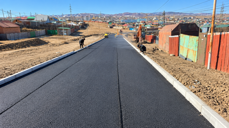 Fresh Asphalt Road Through Mountain Town